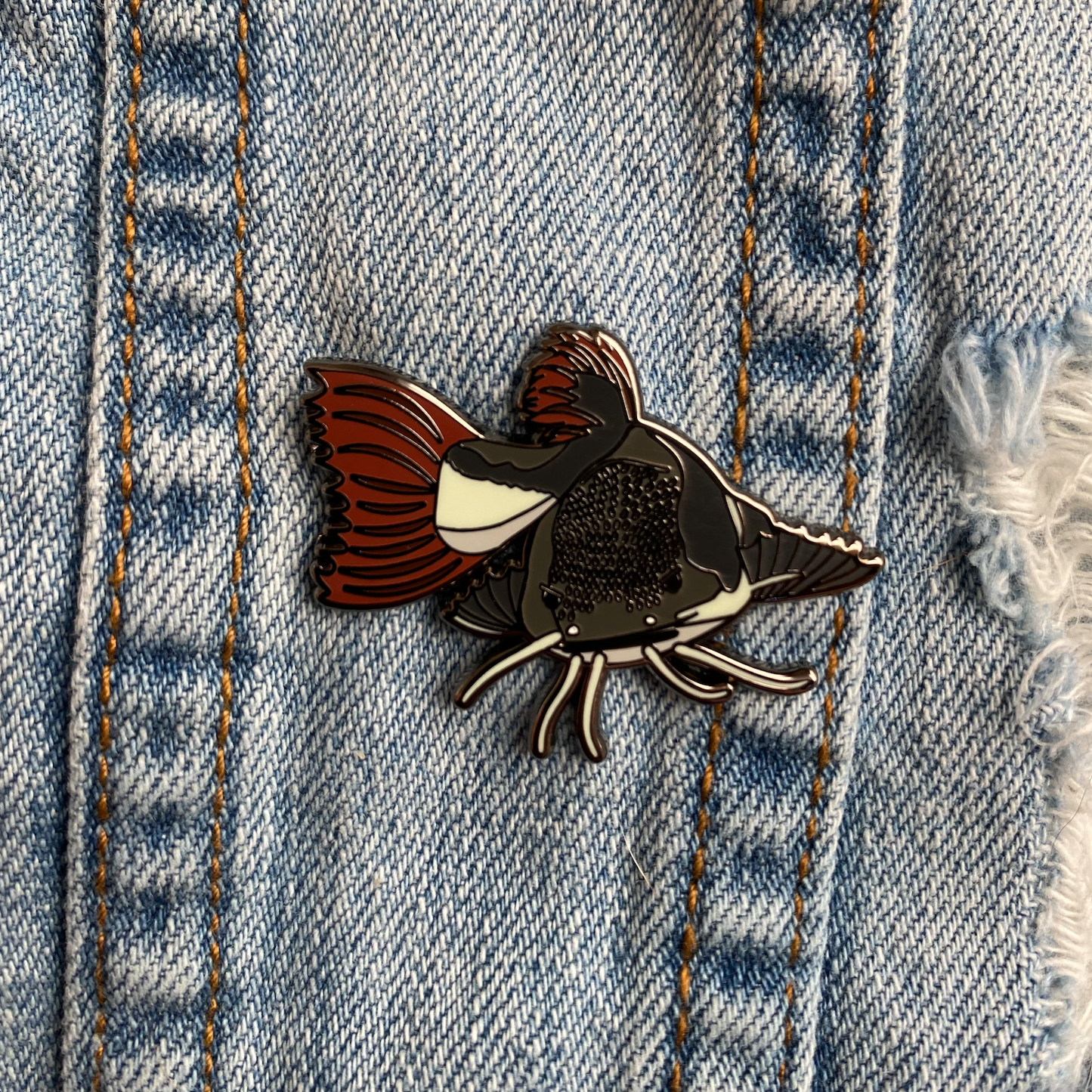 Red tail catfish hard enamel pin. Monster predatory fish pin.